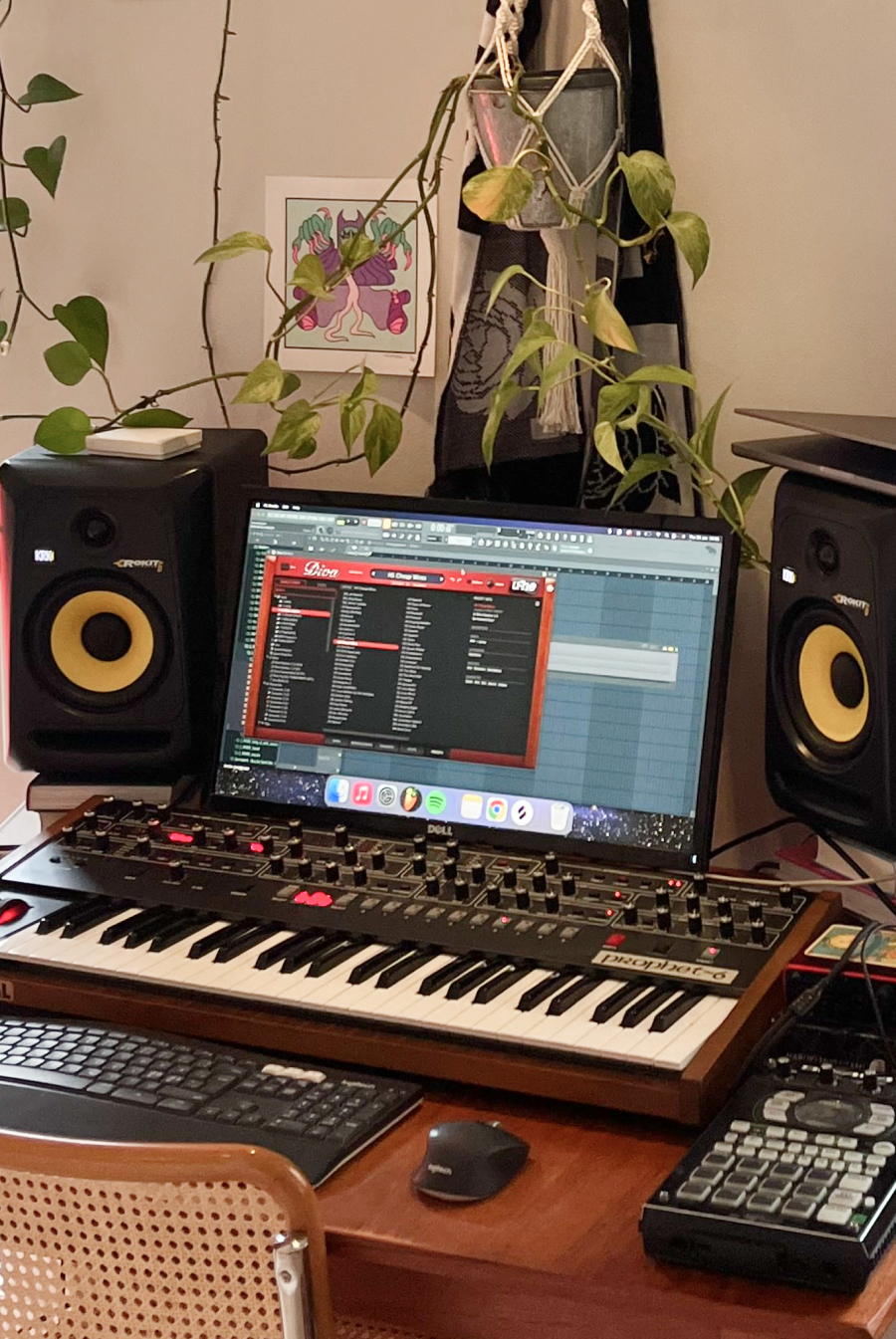 Home studio with FL Studio on a laptop, Prophet synth, and KRK monitors