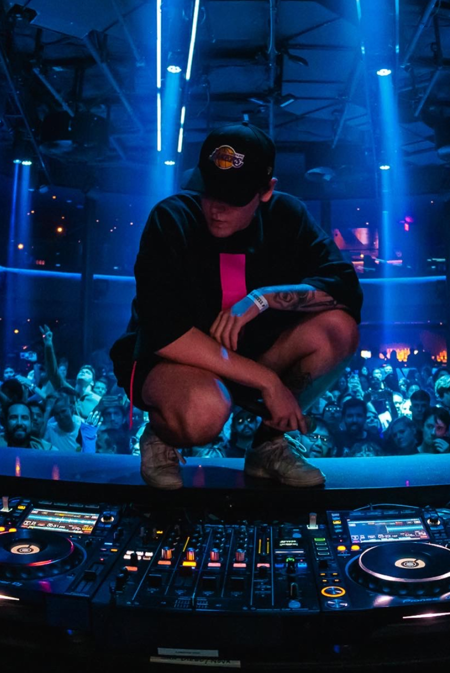DJ performing live behind CDJs and a mixer