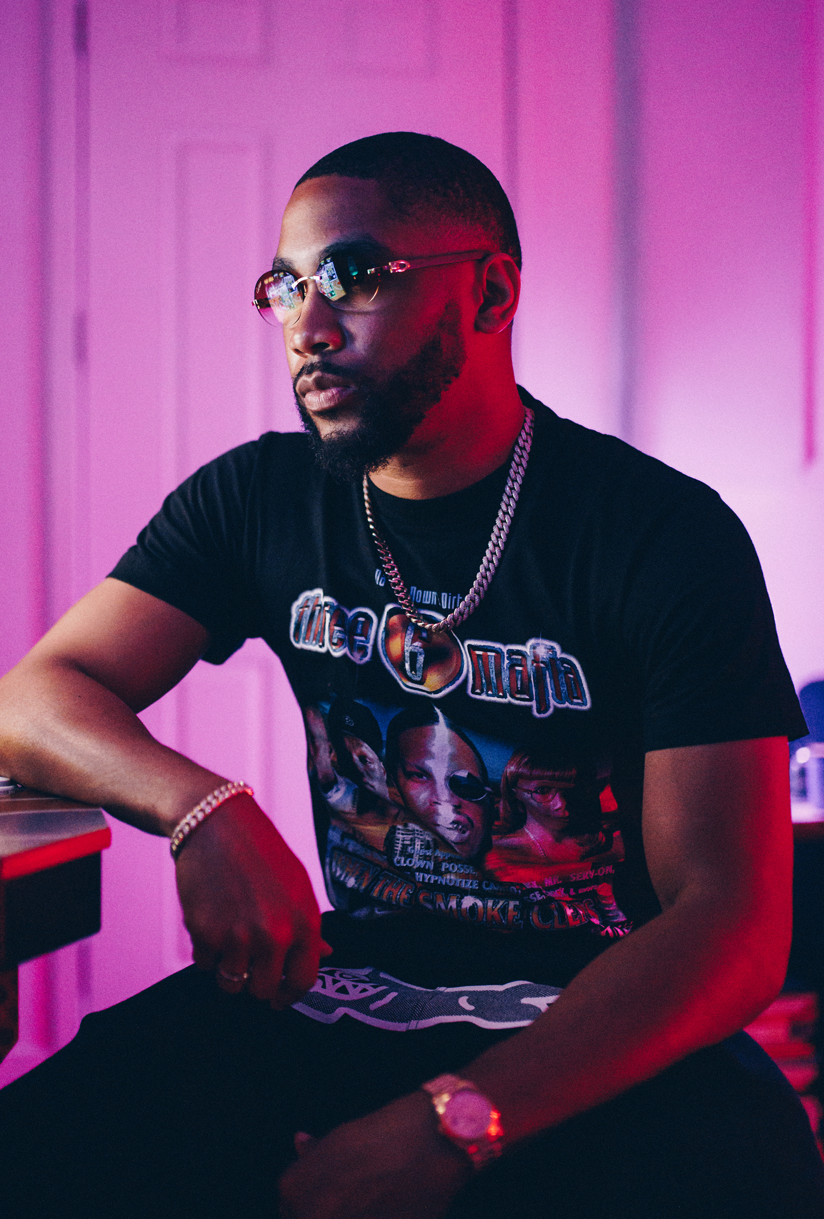 Producer in a studio wearing a Three 6 Mafia shirt