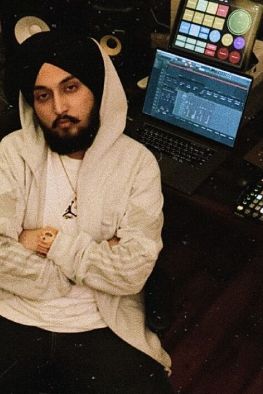 Producer in a studio with FL Studio on a laptop